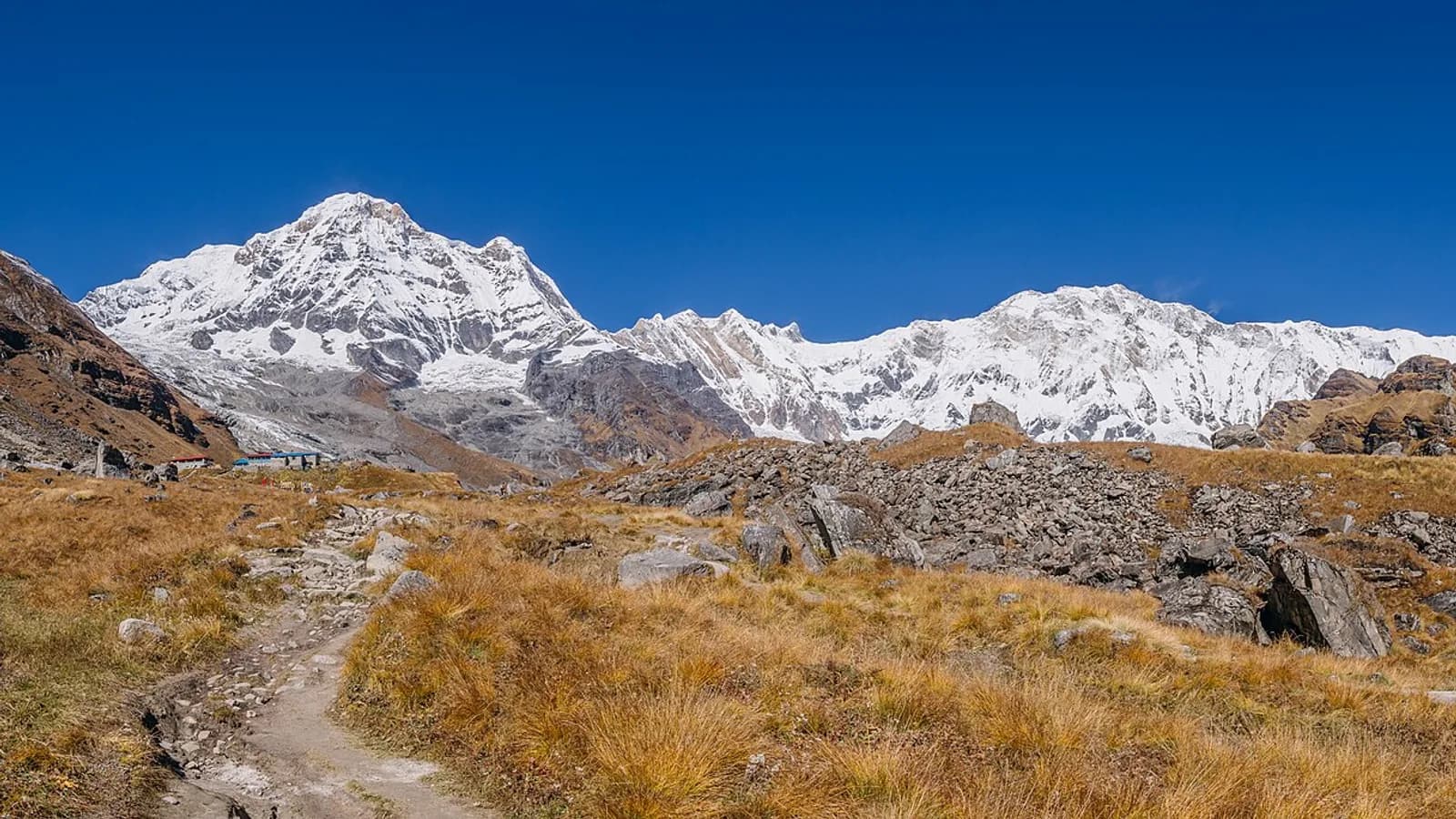 The snow-covered Annapurna I massif rising under a clear blue Himalayan sky in north-central Nepal