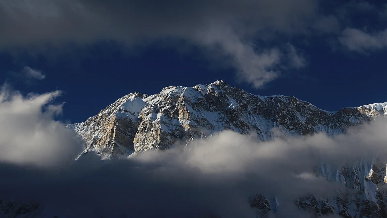 Machhapuchhre, the Fishtail peak, reflected in still water below the Annapurna Sanctuary, the destination of an Annapurna Base Camp helicopter tour
