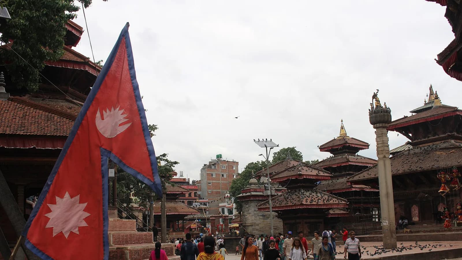 Carved wooden windows and warm brick of traditional Kathmandu Valley architecture, the style echoed by the city's heritage boutique hotels