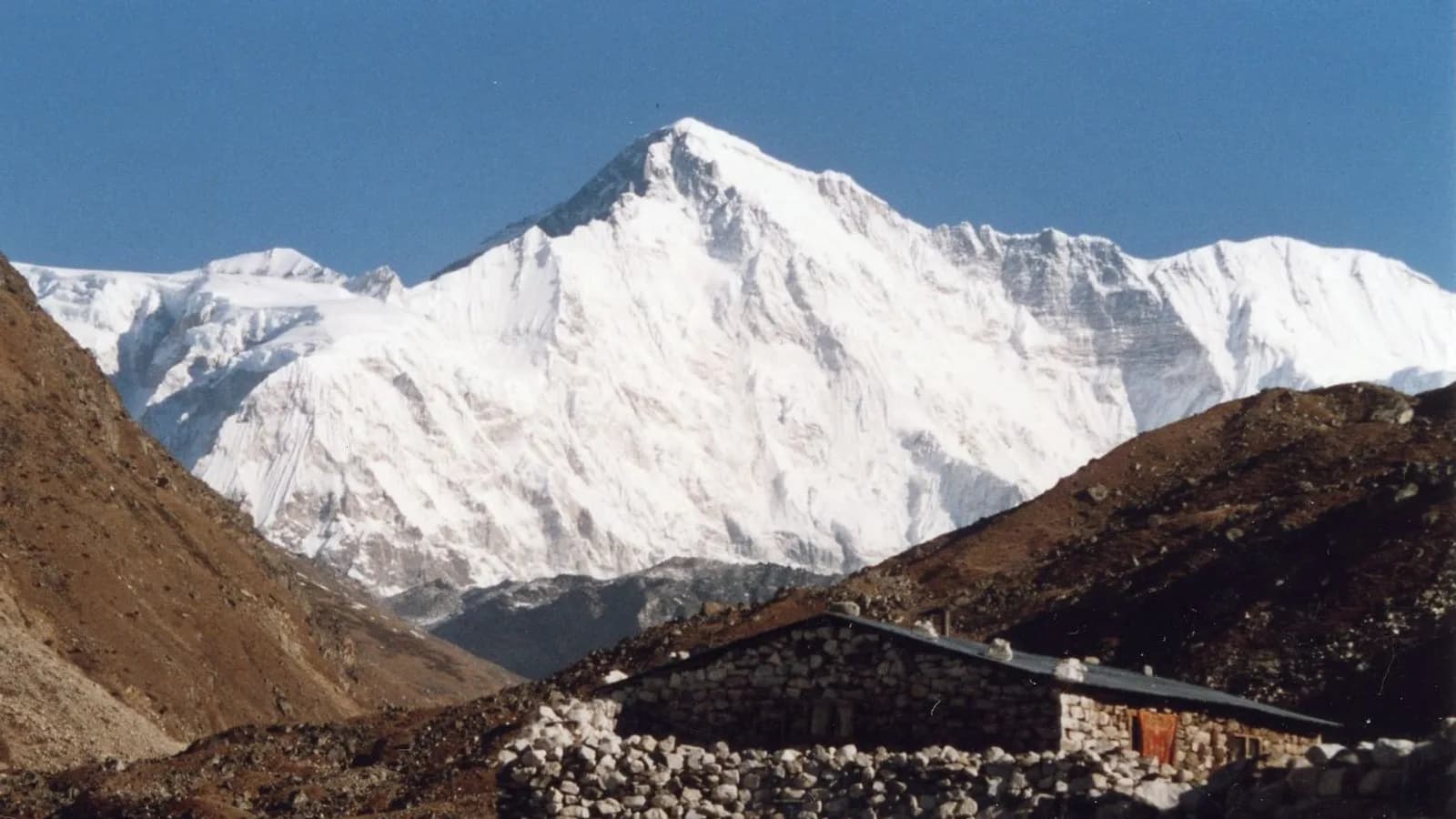The broad snow summit of Cho Oyu rising above the Ngozumba Glacier, seen from the Gokyo valley in Nepal