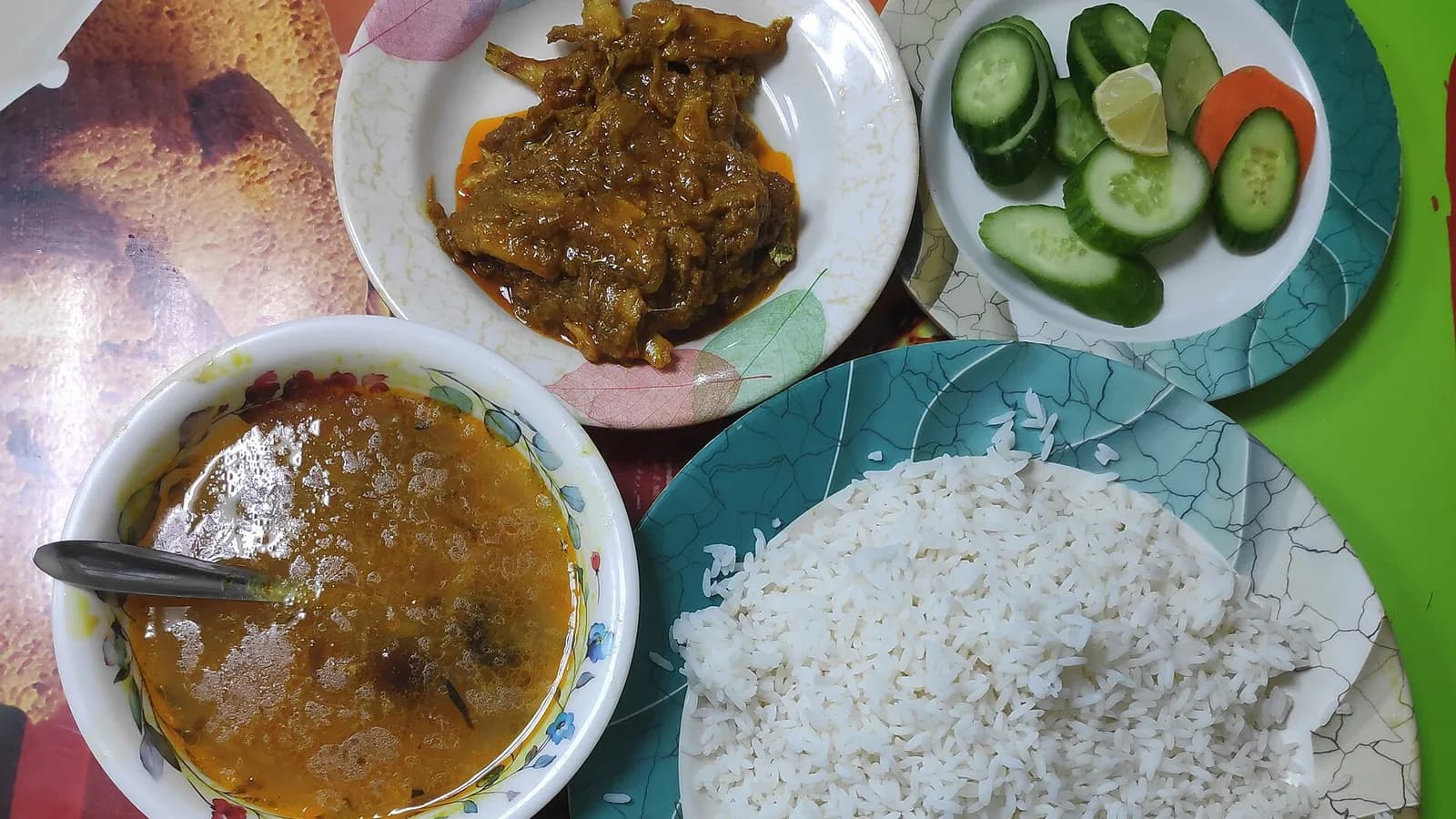 A collage of dal bhat plates with rice, lentil soup, vegetable curry and pickles