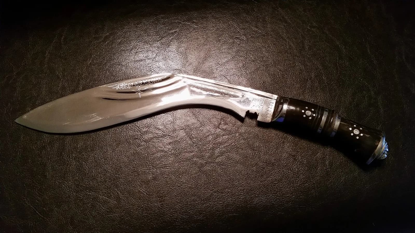 A traditional Nepali khukuri with its forward-curved blade and wooden handle, the knife known worldwide as the Gurkha knife