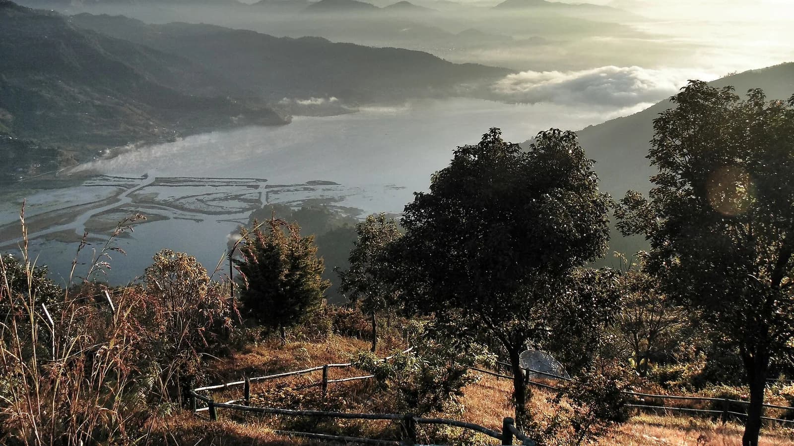 Sunrise over Pokhara with the Annapurna range and valley below, the panorama a hot air balloon flight drifts above