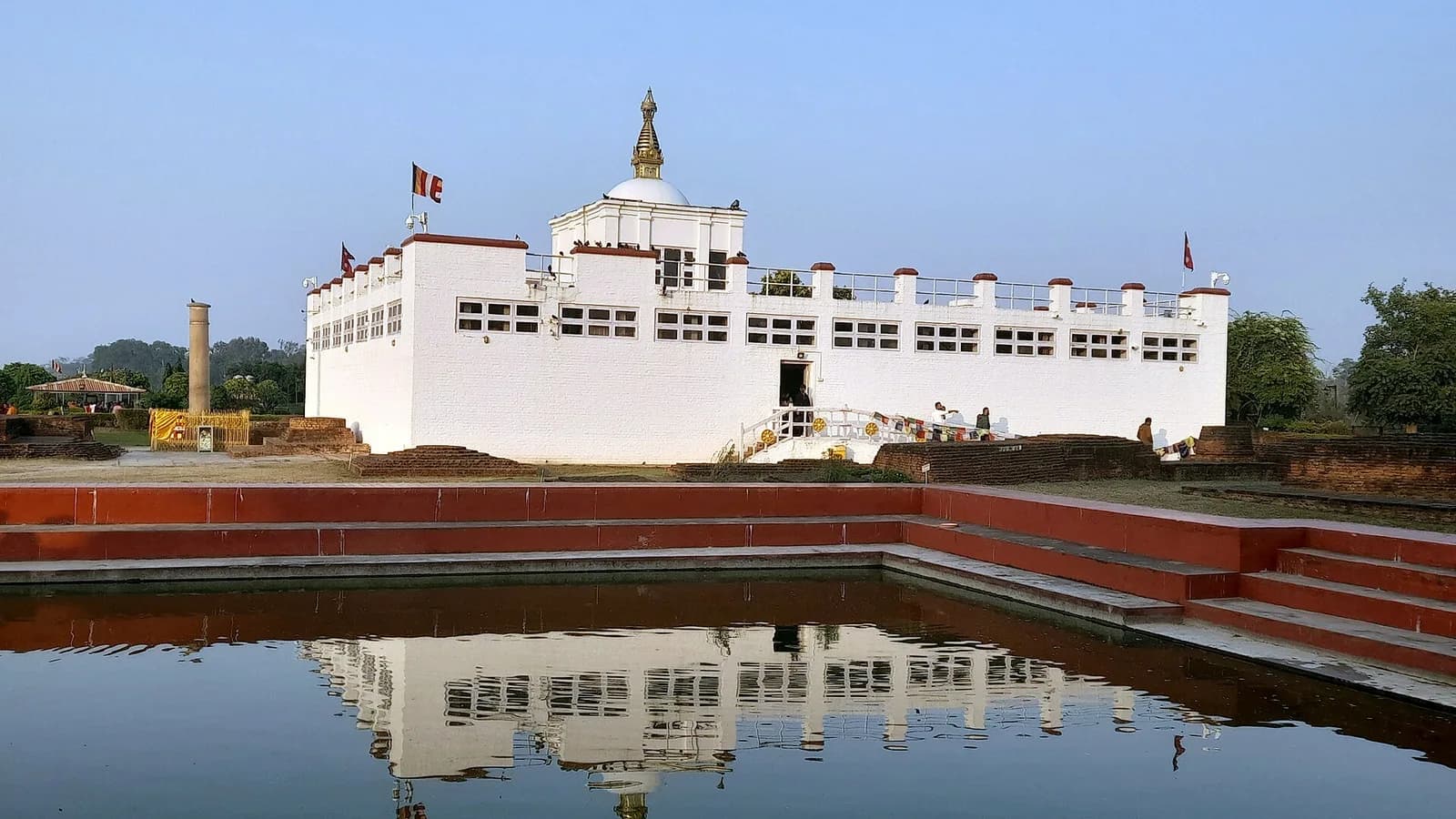 The white Maya Devi Temple beside the sacred pond in the Sacred Garden at Lumbini, Nepal
