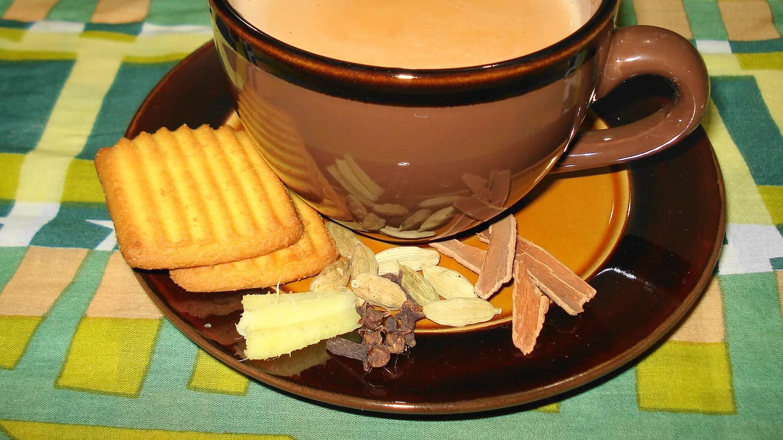 A glass of frothy spiced masala chiya milk tea
