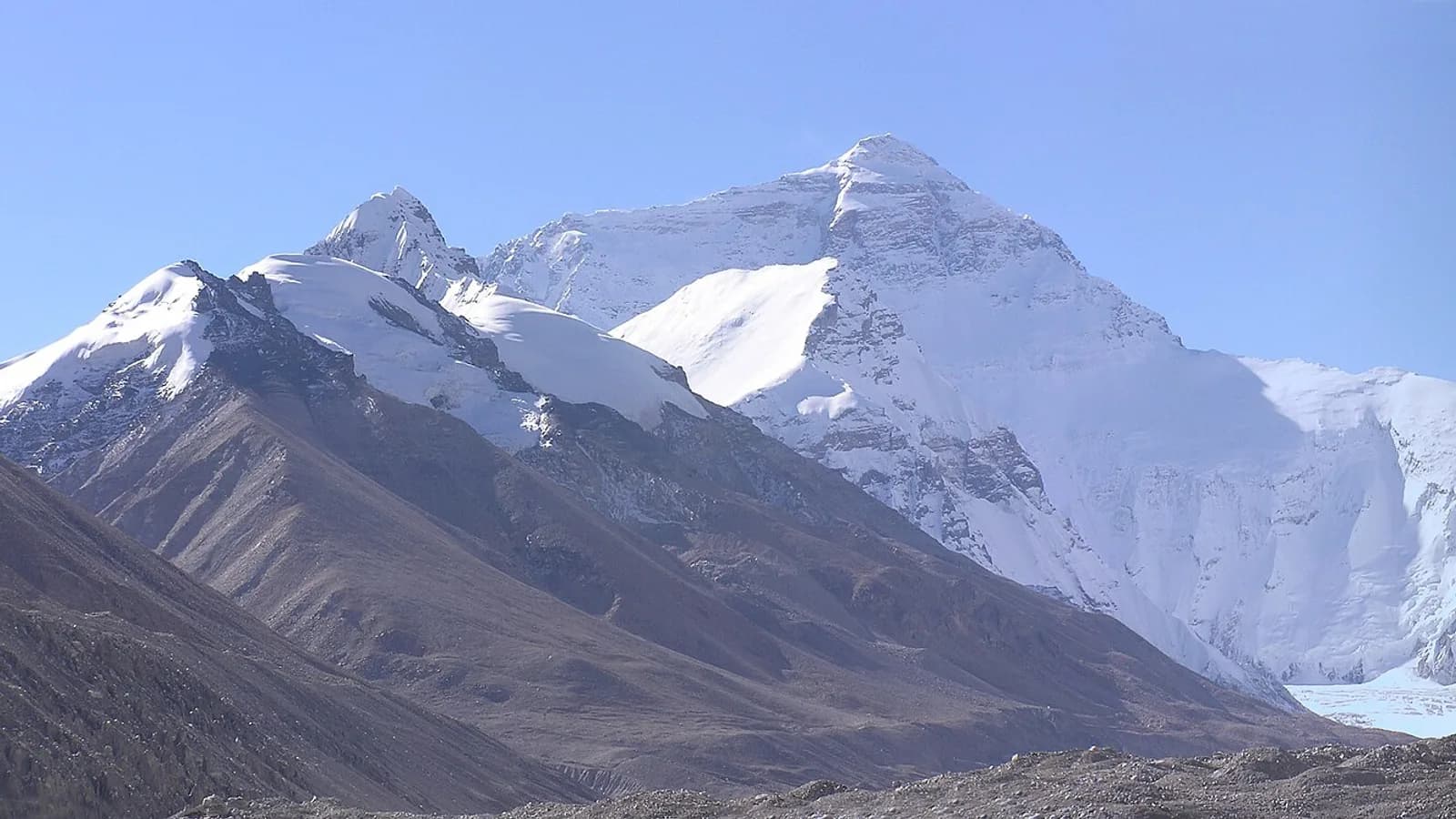 Mount Everest seen from the Tibetan base camp, its snow-covered summit pyramid rising above the surrounding ridges
