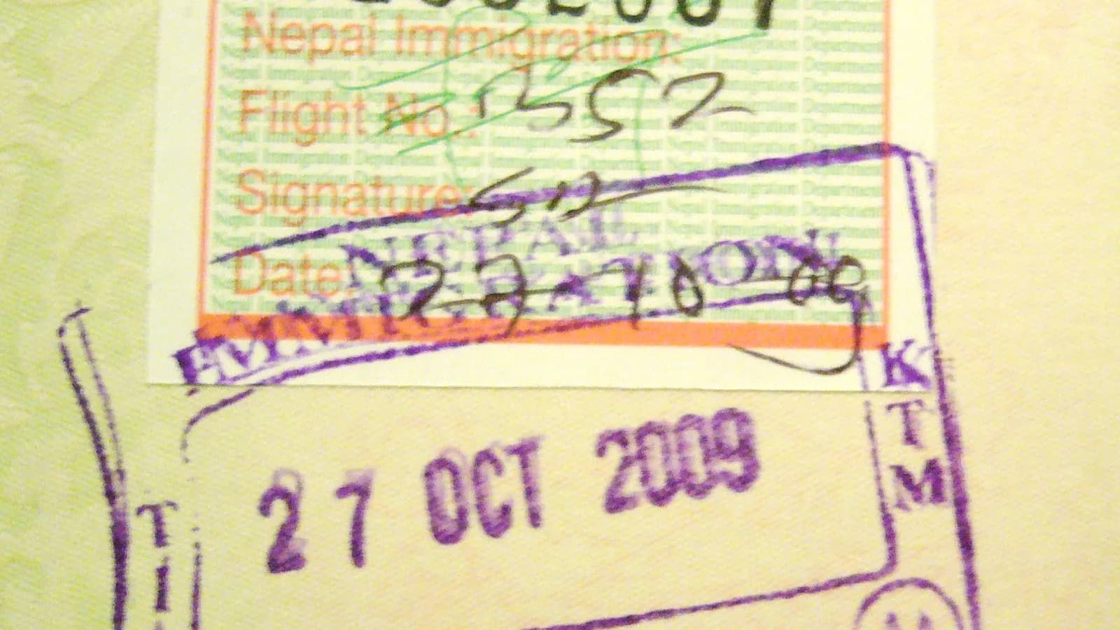 A Nepal tourist visa sticker and arrival stamp in a passport