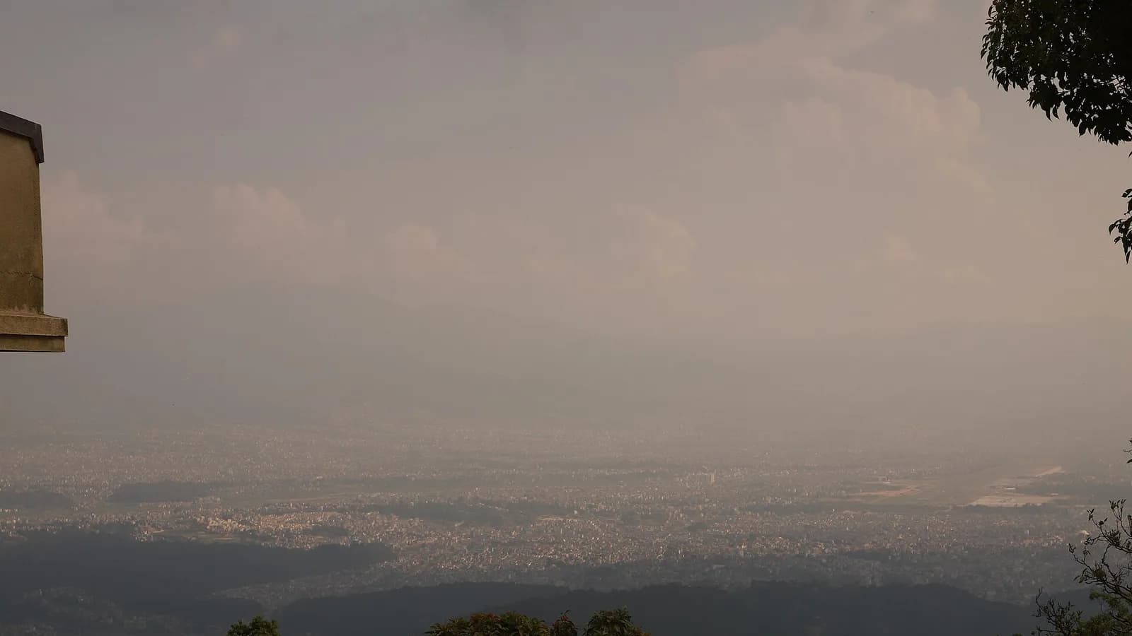 Panoramic view of the Kathmandu Valley seen from the Shivapuri hills under a layer of haze