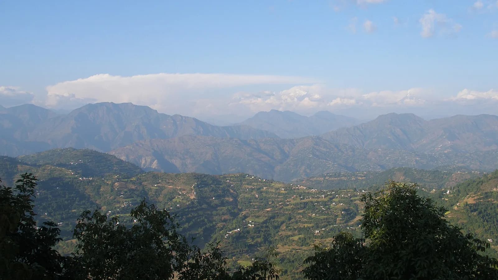 Phewa Lake and the green hills of Pokhara with mountains rising behind