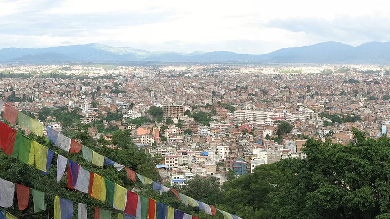 Wide panorama of the Kathmandu Valley with the city spread beneath surrounding hills