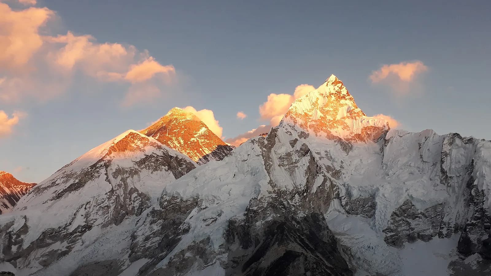 Panorama of the snow-capped Annapurna massif rising above green Nepali foothills