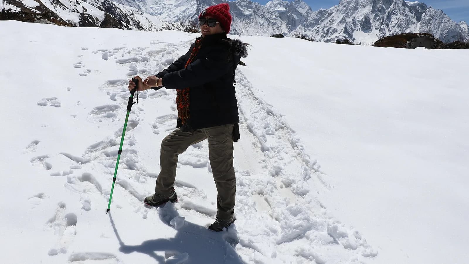 Snow-covered Annapurna I massif rising above forested Himalayan foothills in Nepal