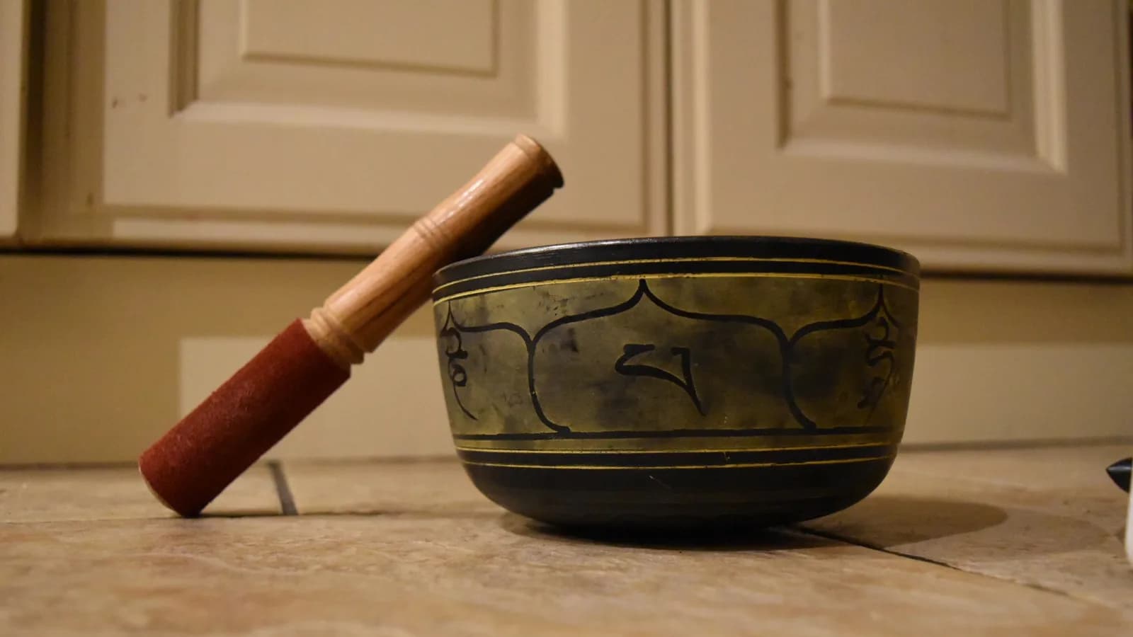 A hand-hammered Himalayan singing bowl with a wooden mallet, the kind sold across Kathmandu