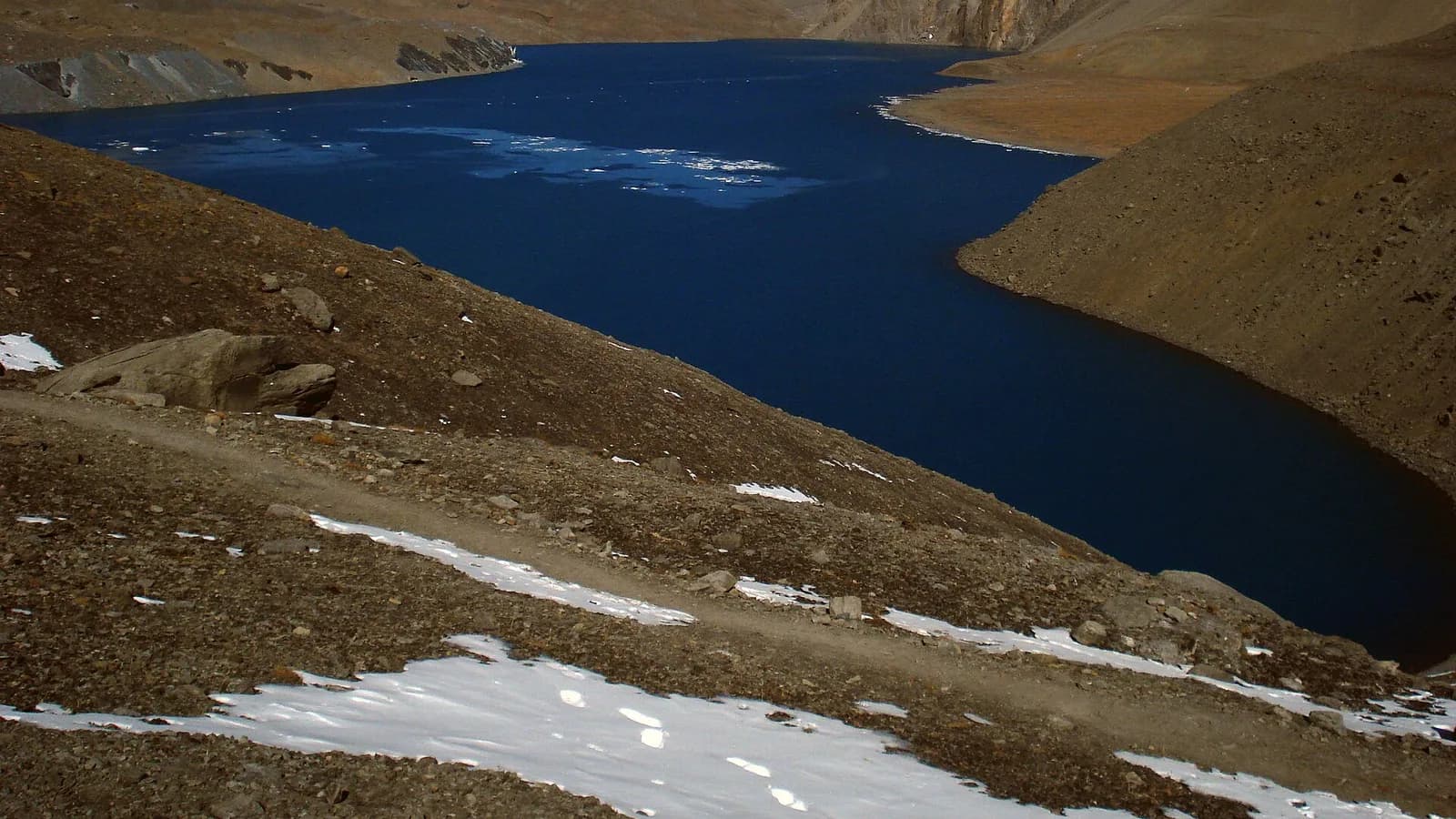 Turquoise Tilicho Lake below snow peaks in the Annapurna range, Manang district