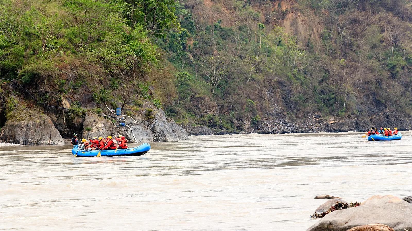 A raft of paddlers working through a wave train on the Trishuli River in Nepal